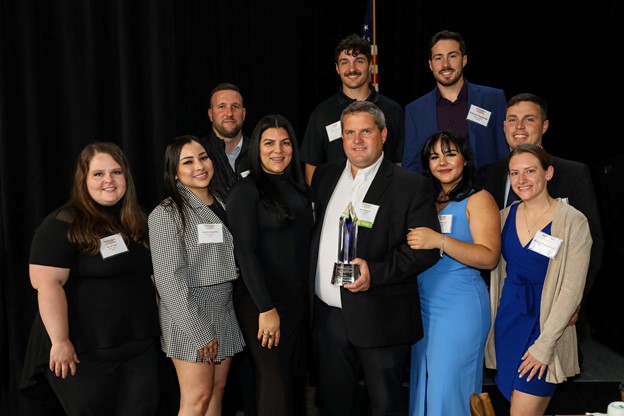 Nick Fitzpatrick posing for the award with his family