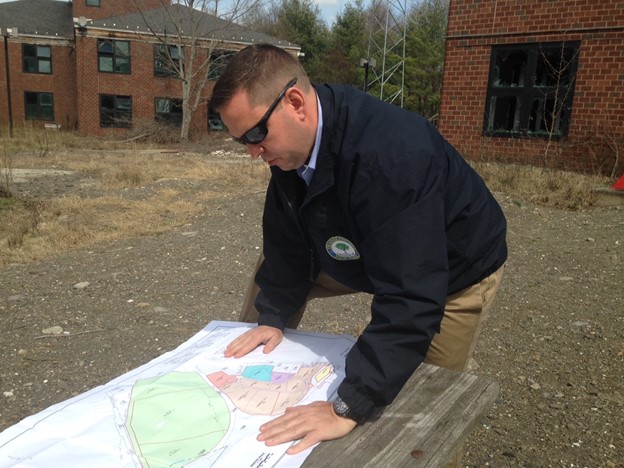 Orange County Executive Steven M. Neuhaus looks over a map of the Camp LaGuardia property. 